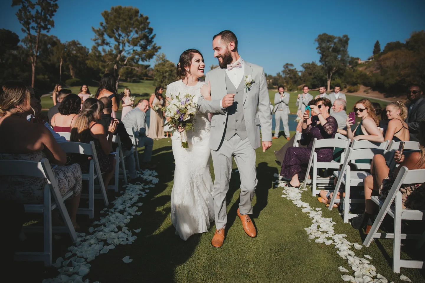 Los Angeles wedding photographer and videographer photo of newlyweds walking through cheering guests after their ceremony